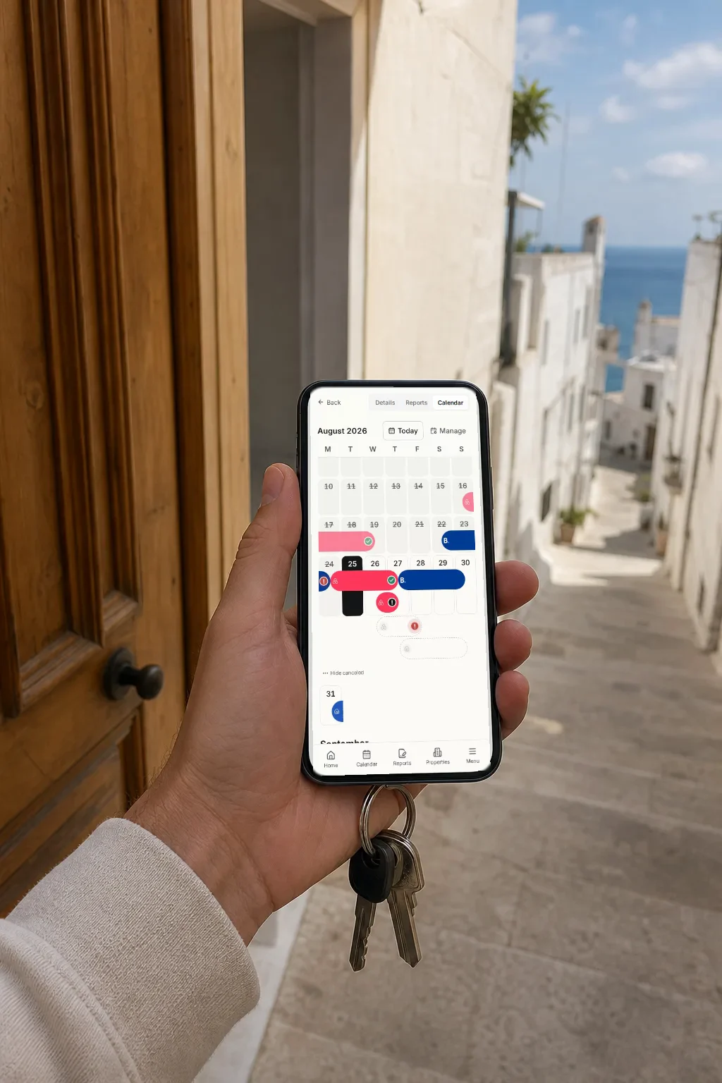 A hand holds a phone in front of a Mediterranean apartment door; on the screen, the Regi reservations calendar with August stays.